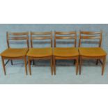 A set of four mid 20th century Danish teak dining chairs in mustard upholstery. H.77cm