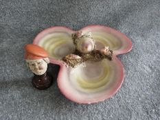 An Italian majolica seashell plate and porcelain head on wooden stand. Head signed 'porcellane, g.