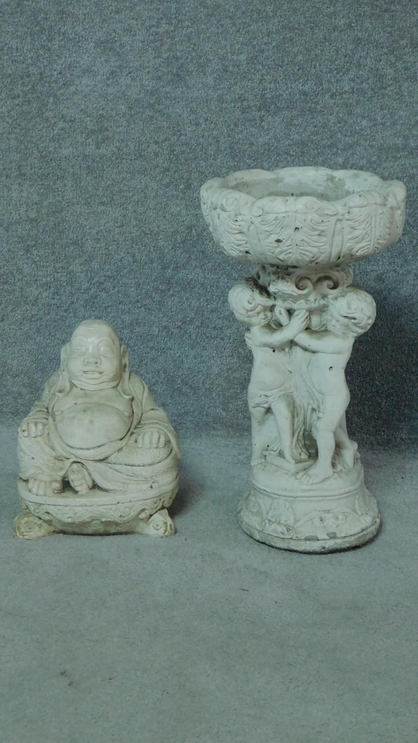 A painted concrete birdbath and seated buddah. Birdbath with three cherubs holding an urn. H.54 (