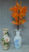 Two large oriental ceramic vases. One with lotus flower decoration and the other with birds and