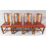 A set of four mid 20th century oak dining chairs with carved cresting in the Jacobean style. H.87cm