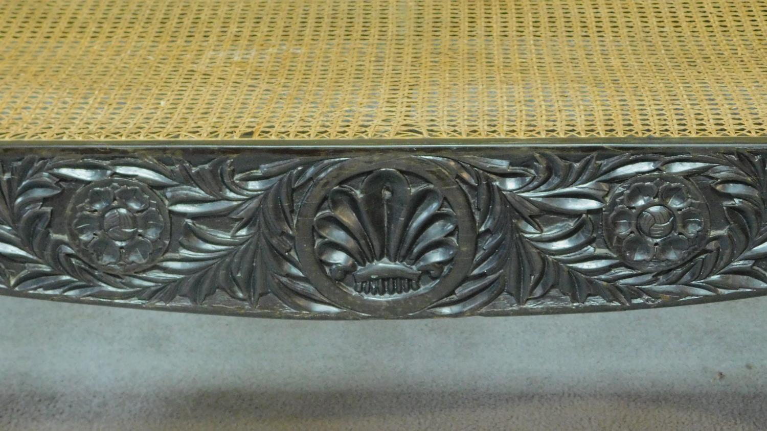 A Colonial style carved hardwood scroll end sofa with caned back and sides on scroll supports. H.101 - Image 5 of 9
