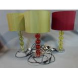 A trio of modern lamps with blown glass bauble stems and satin shades. H 53 cm.