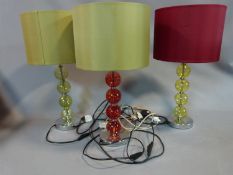 A trio of modern lamps with blown glass bauble stems and satin shades. H 53 cm.