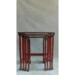 A nest of four Chinese style red lacquered graduating occasional tables on swept square section