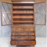 A late Georgian mahogany library bookcase with upper glazed section above fitted central