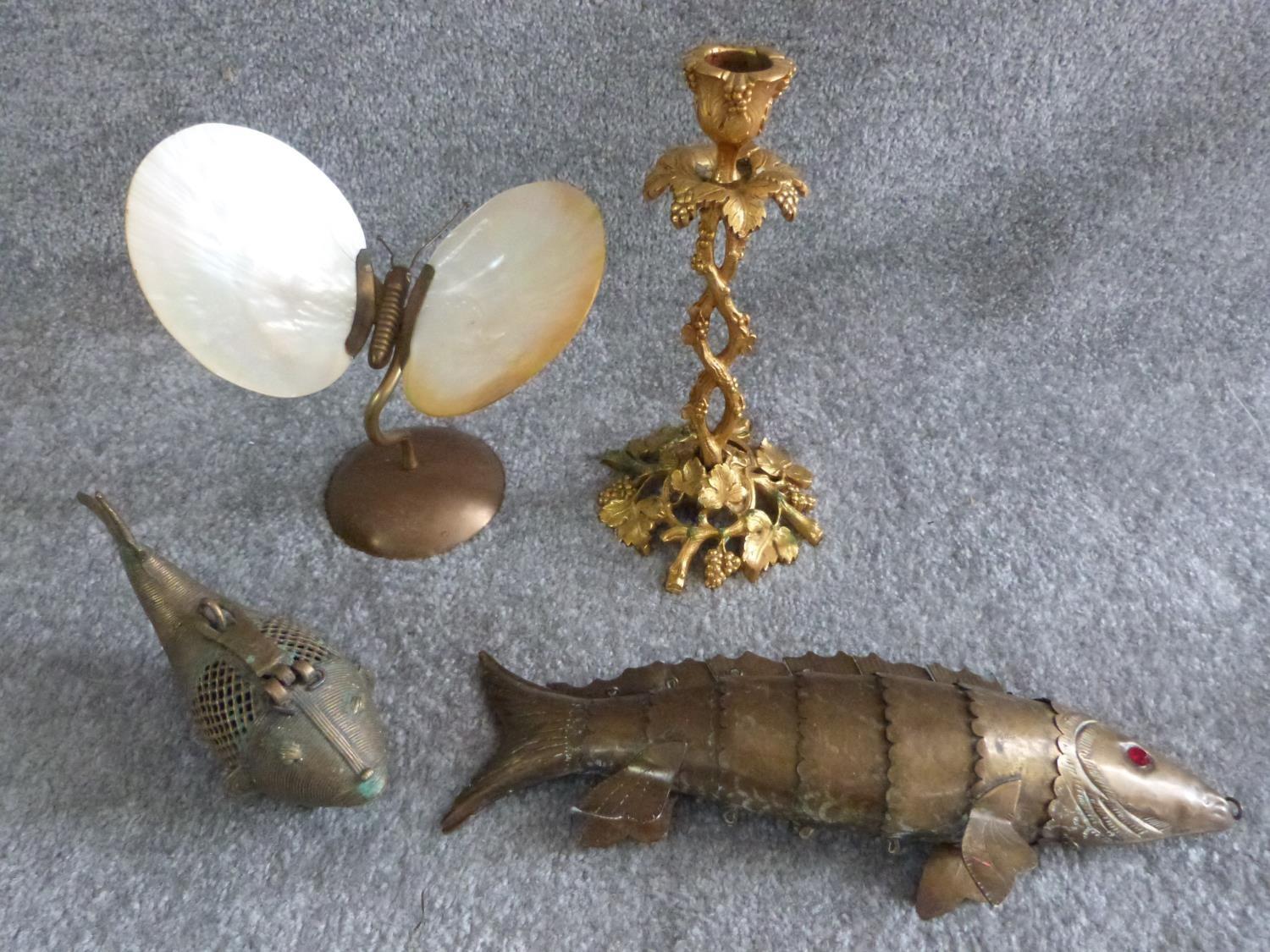 A collection of vintage brass items, including a brass butterfly with oyster shell wings, an