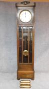 A mid 20th century German oak longcase clock with weights and pendulum. H.202cm (reported as