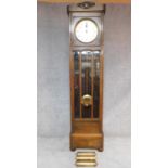 A mid 20th century German oak longcase clock with weights and pendulum. H.202cm (reported as