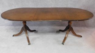 A Georgian style mahogany D end twin pedestal dining table with extra leaf. H.75 W.217 D.100cm