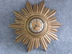 A vintage sunburst giltwood clock by Smiths Sectric. Label on side. H 40cm.