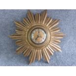 A vintage sunburst giltwood clock by Smiths Sectric. Label on side. H 40cm.