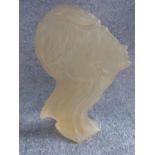 A frosted acrylic Art Deco statue of a male and female figure side profile. Label to base reads