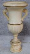 An alabaster table lamp of classical twin handled urn form on pedestal base. H.48cm
