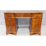 A Georgian style mahogany three section pedestal desk with a green tooled leather inset top and an