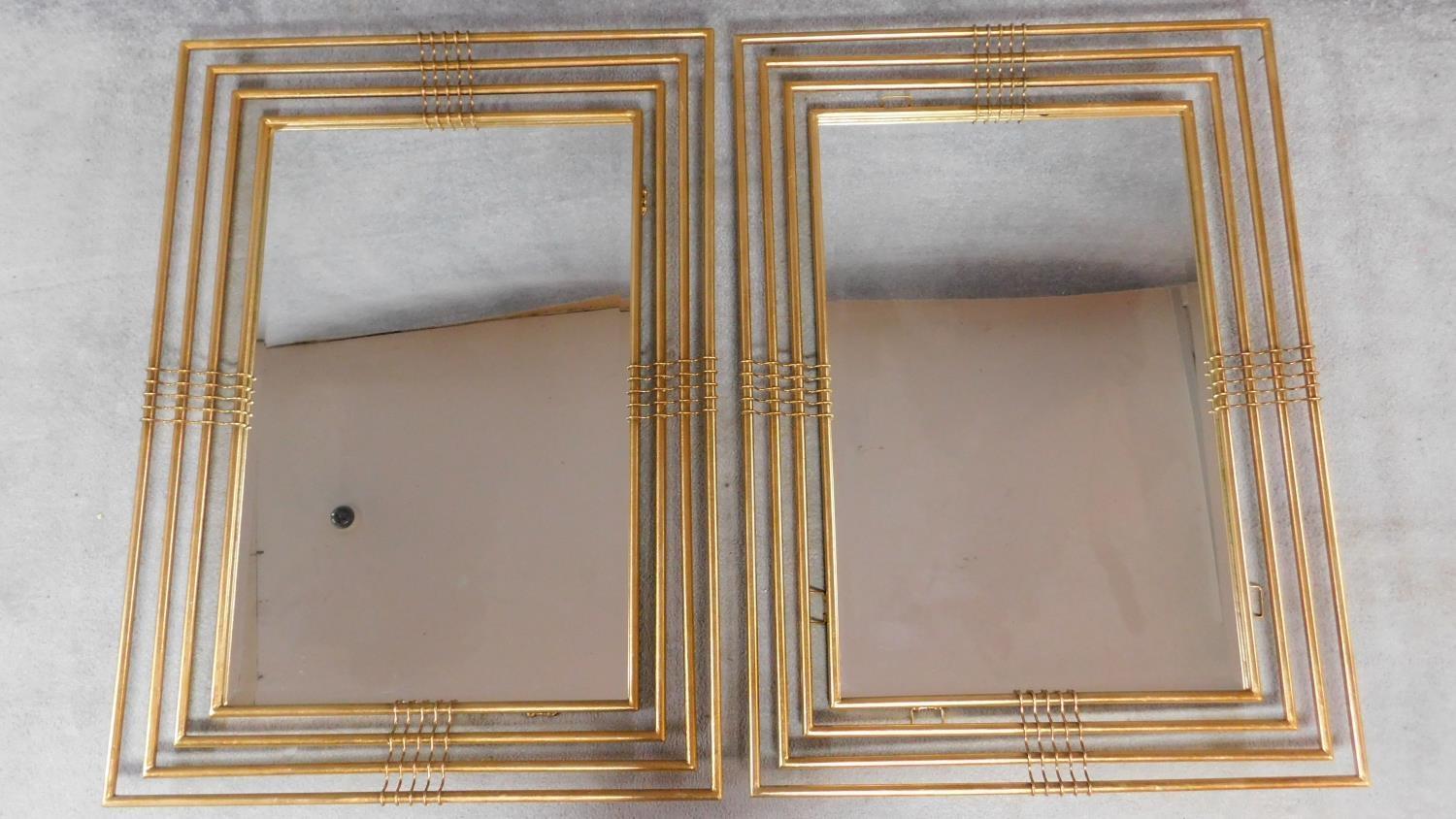 A pair of large gilt metal framed contemporary wall mirrors fitted bevelled plate glass. 115x84cm