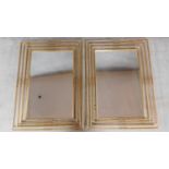 A pair of large gilt metal framed contemporary wall mirrors fitted bevelled plate glass. 115x84cm