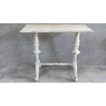 A 19th century distressed painted centre table on turned stretchered supports. H.70 W.86 D.42cm