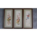Three Chinese framed silk paintings depicting flowers and birds with artists seal. 46x22cm