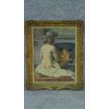 A framed oil on board of a nude woman sitting on a bed in front of a fire in a gilded frame.