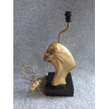 An Art Deco brass lamp with side profile of a lady, mounted on a painted wooden base. H 47cm.