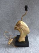 An Art Deco brass lamp with side profile of a lady, mounted on a painted wooden base. H 47cm.