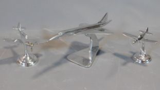 A collection of three vintage style desk top chromium aeroplane models.