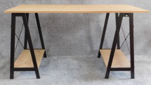 A contemporary trestle style desk. H.75 W.140 D.60cm