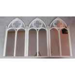 A set of three wrought metal painted gothic style mirrors. 103x54cm