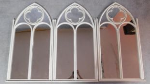 A set of three wrought metal painted gothic style mirrors. 103x54cm
