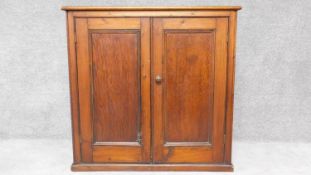 a 19th century stained pine two door cabinet. H.92 W.95 D.47cm