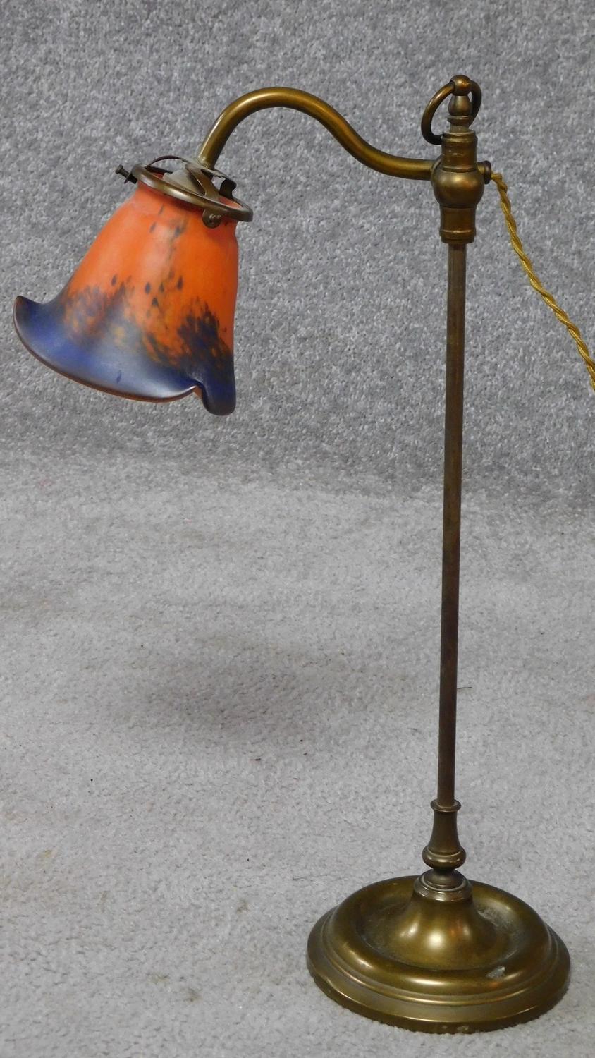 An antique brass lamp with art glass shade. Shade signed. H.47cm