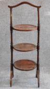 An Edwardian mahogany and inlaid three tier cakestand. H.90cm