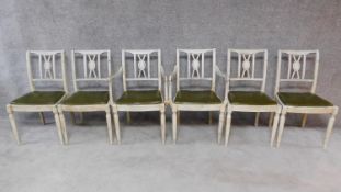 A set of six painted Regency dining chairs with faux leather drop in seats, including two armchairs.