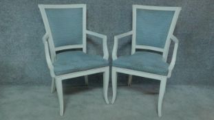 A pair of French style white painted open armchairs. H.93cm