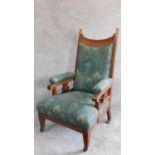 A late 19th century carved oak armchair in Liberty fabric. H.106cm