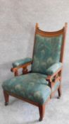 A late 19th century carved oak armchair in Liberty fabric. H.106cm