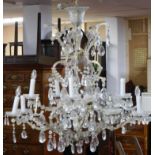 A large sixteen branch chandelier with crystal drops on gilt metal frame. H.105 W.105cm (some