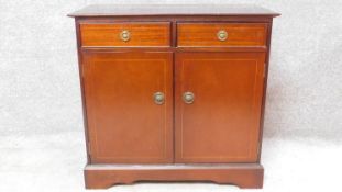 A Georgian style mahogany inlaid two door cabinet. H.76 W.81 D.46cm