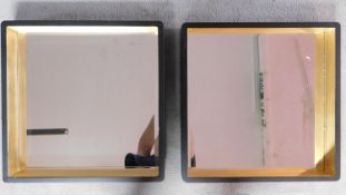 A pair of contemporary gilt and ebonised square wall mirrors. 53x53cm