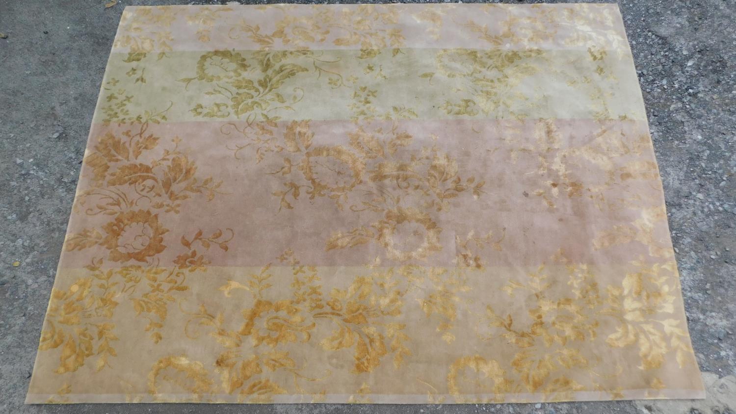 A Suzanne Sharp hand made floral rug with repeating petal and spandrel motifs 273x372cm