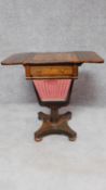 An early Victorian rosewood drop flap sewing table with pull out basket, frieze drawer and chequer