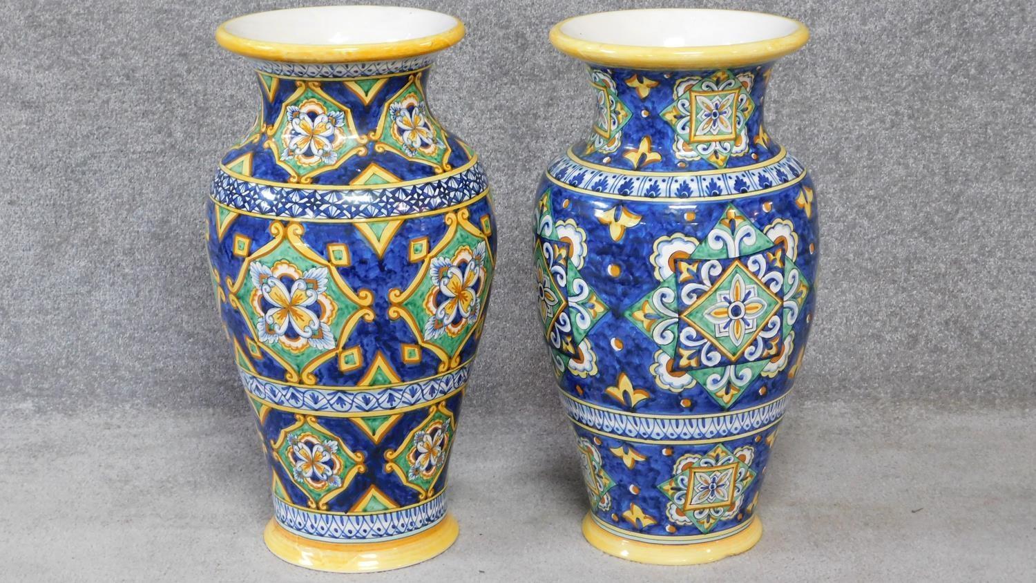 Two large Italian majolica vases with colourful hand painted abstract design. Inscribed on the