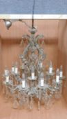 A twelve branch chandelier on a metal frame fitted with crystal swags and drops. H.80 W.75cm