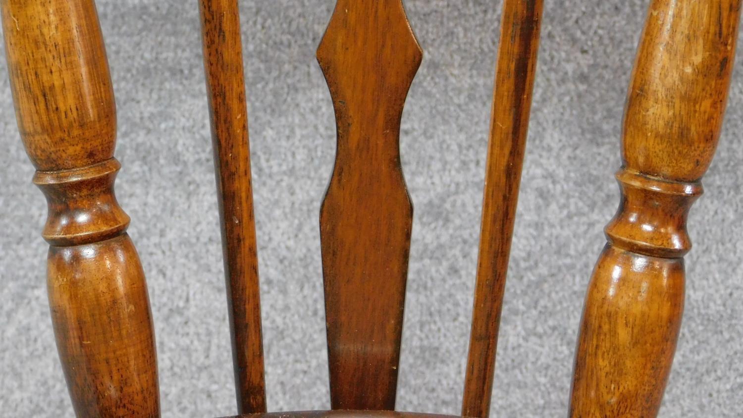 A Victorian walnut revolving piano stool with foliate carving to the back on reeded stretchered - Image 4 of 14