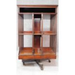 A large late 19th century mahogany revolving bookcase on brass casters. H.106 W.65 D.64cm