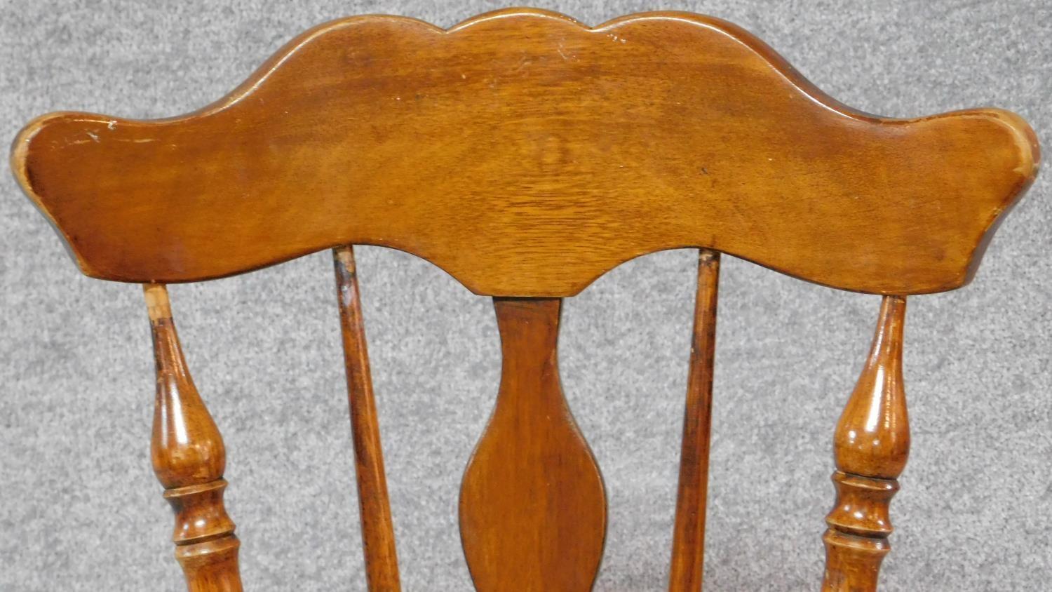 A Victorian walnut revolving piano stool with foliate carving to the back on reeded stretchered - Image 3 of 14