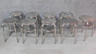 A set of nine low chrome stools. H.43cm