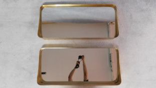 A pair of contemporary gilt metal framed mirrors. 41x91cm