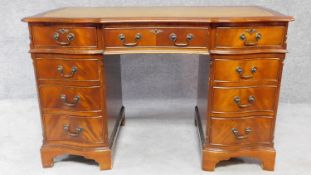 A Georgian style mahogany three section pedestal desk with a green tooled leather inset top and an